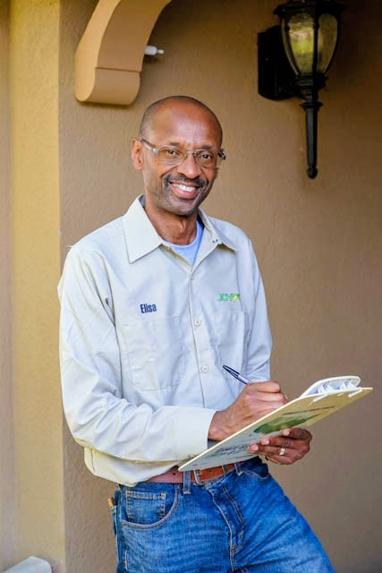 Joy Pest Controls technician completing a guaranteed pest treatment at a Tulsa home